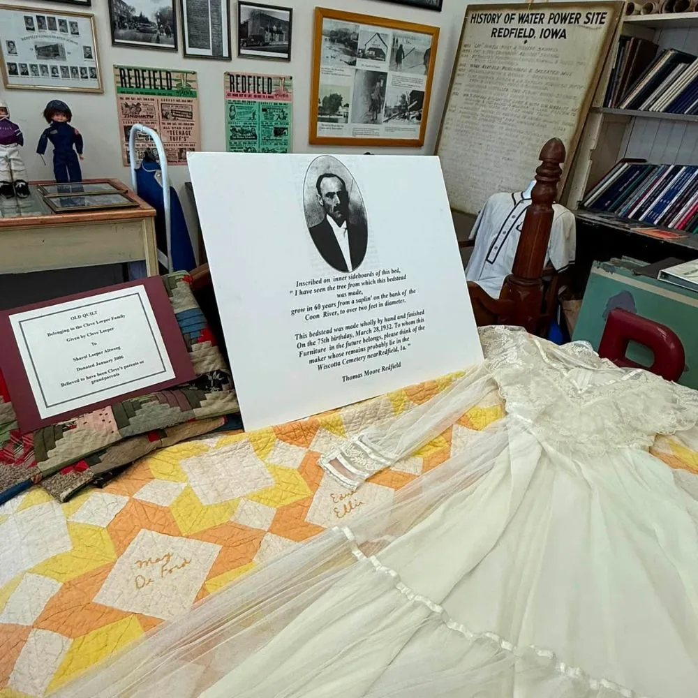 Historic wedding dress, signature quilt, and Redfield family exhibits inside the museum