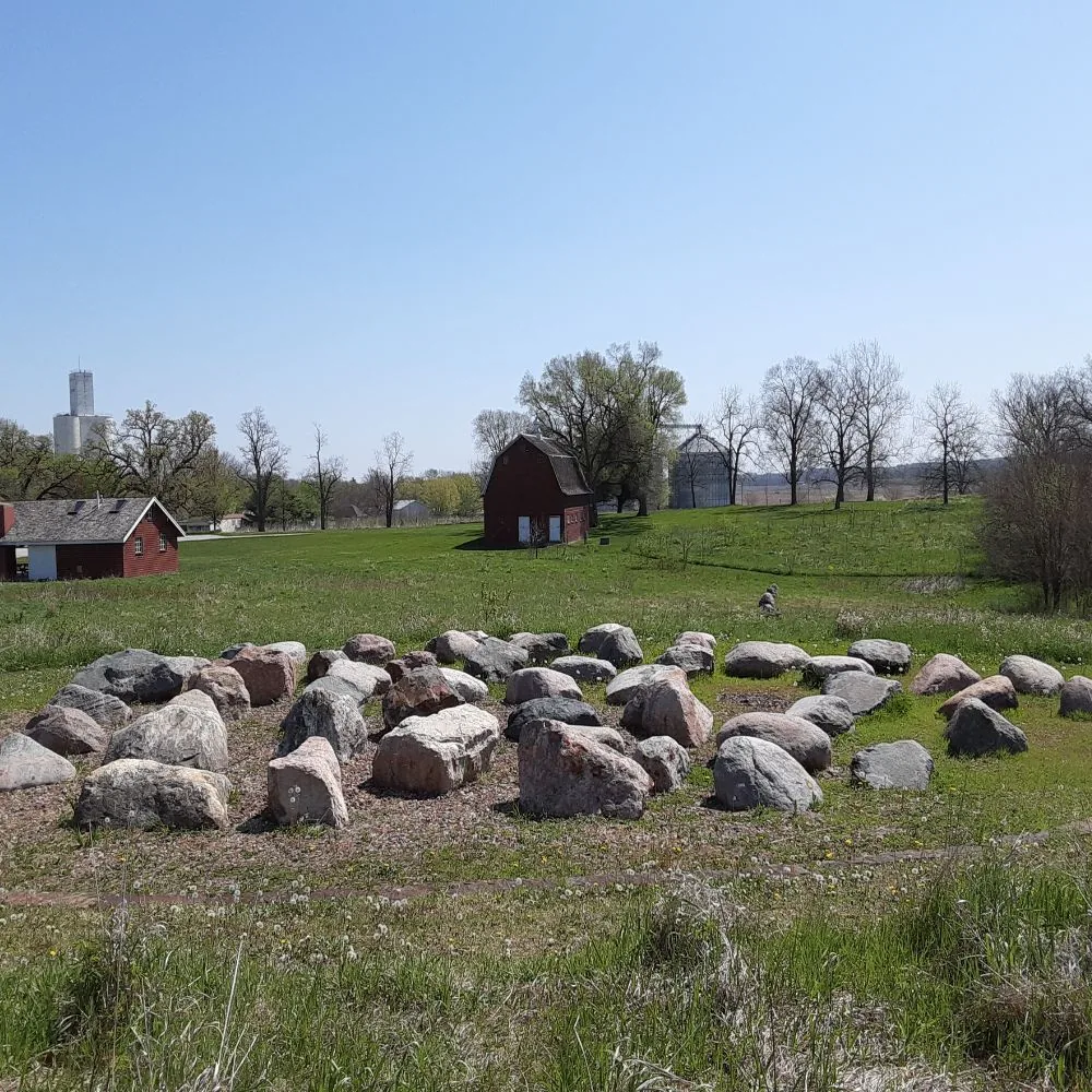 Prairie rock garden with the Tile Barn and park buildings in the distance