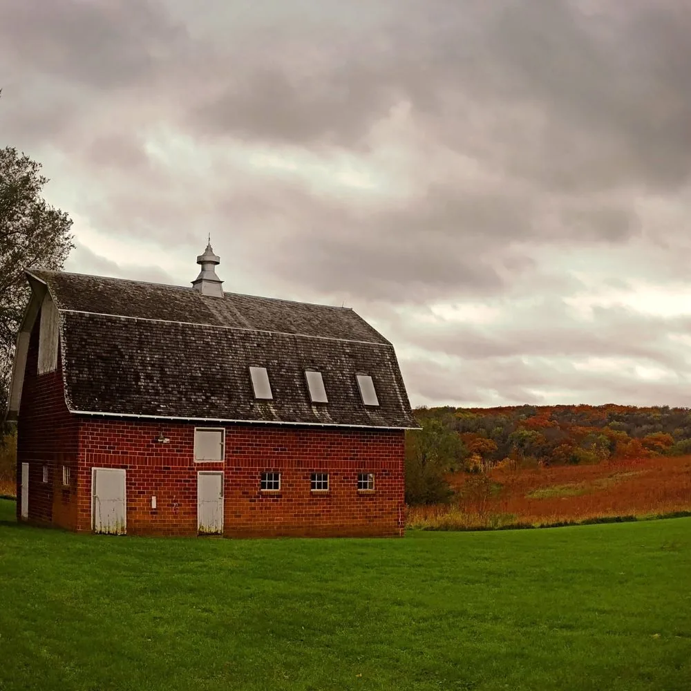 Historic Tile Barn before restoration overlooking autumn prairie at Hanging Rock Park