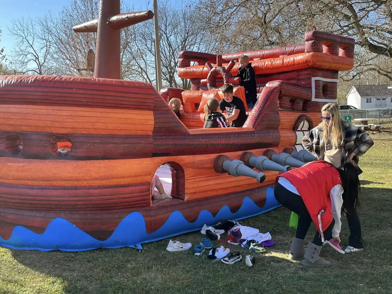 Kids climbing and playing on a giant inflatable pirate ship at Redfield City Park during Halloween in the Park