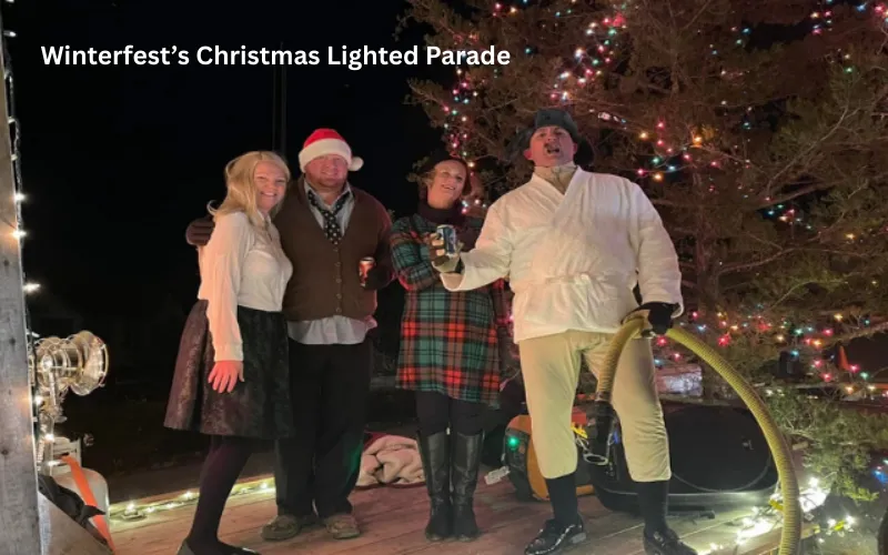 Costumed riders on a float decorated with holiday lights in the Winterfest Christmas Lighted Parade